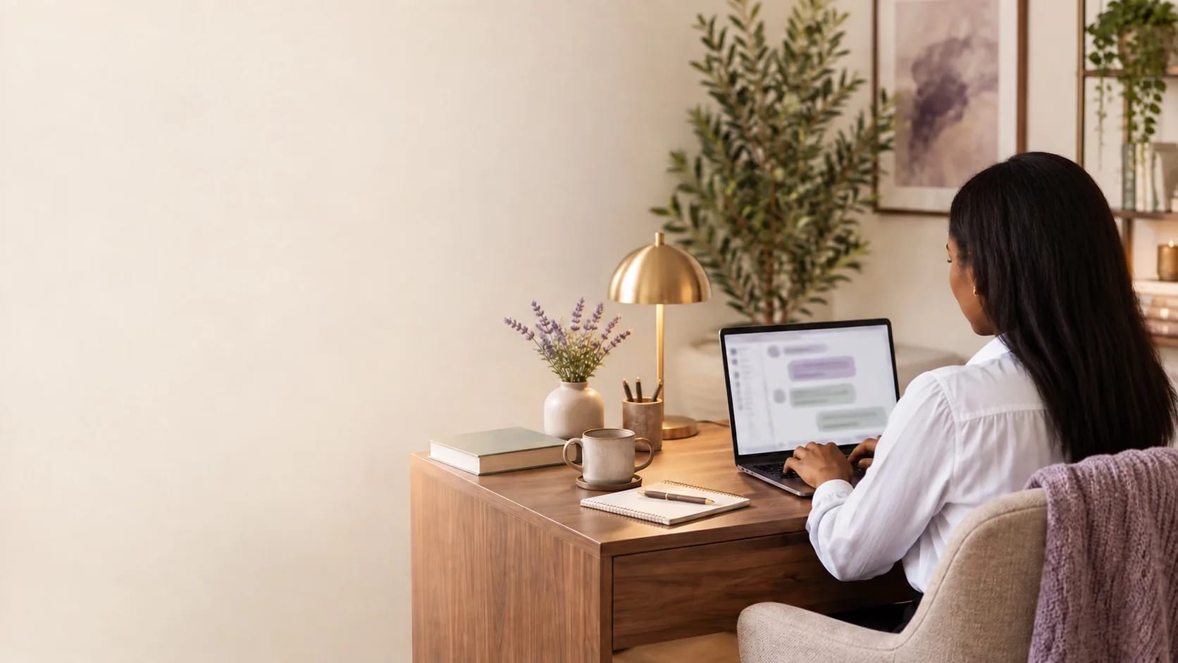 Woman in a white shirt using an AI assistant at a laptop