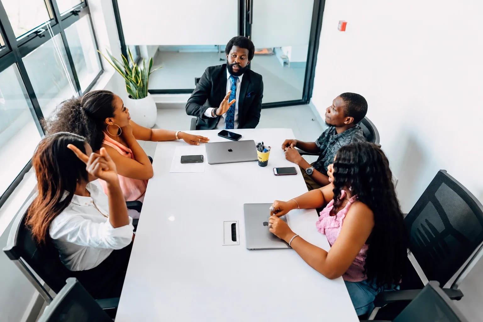 Colleagues discussing goals around a meeting table